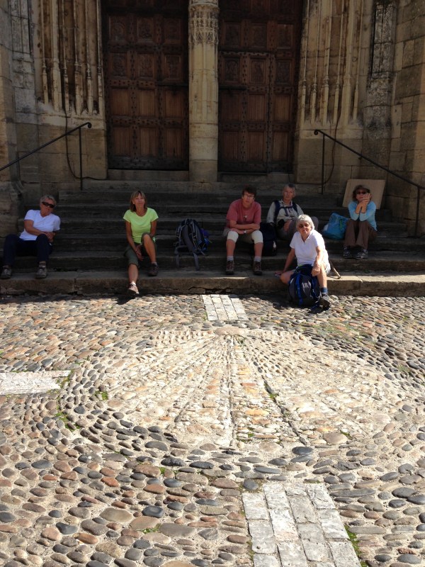 Resting on the steps of the Gothic church. Note the shell pattern in the stone courtyard.